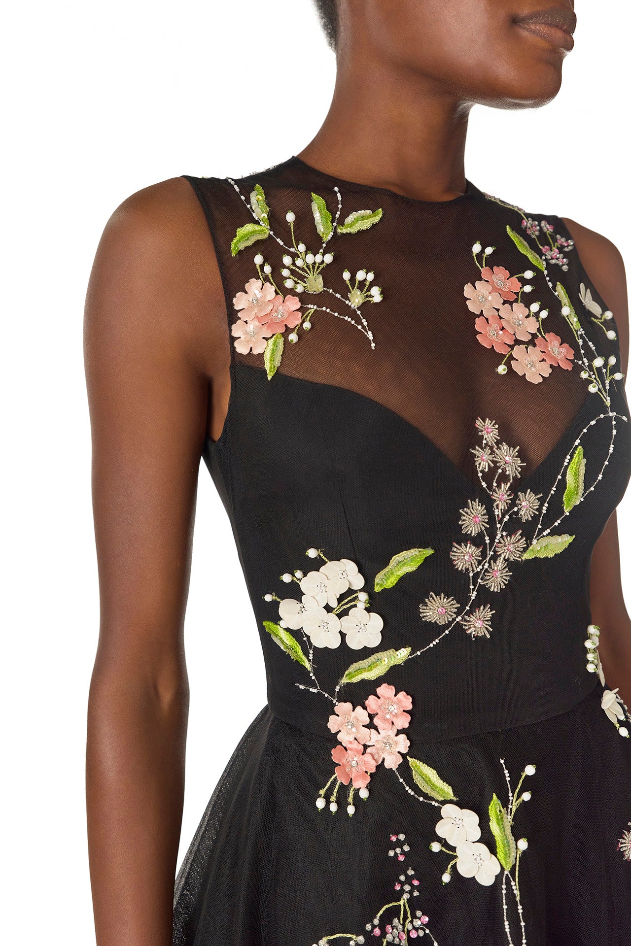 Monique Lhuillier Spring 2025 Sleeveless, noir tulle gown with floral embroidery and slight high-low hem - detail.