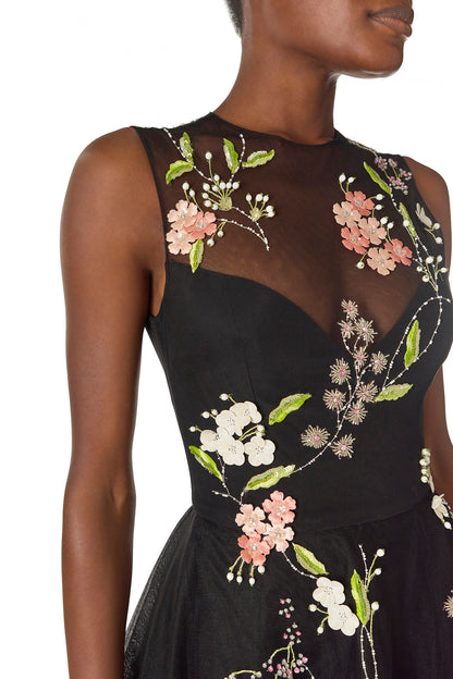 Monique Lhuillier Spring 2025 Sleeveless, noir tulle gown with floral embroidery and slight high-low hem - detail.
