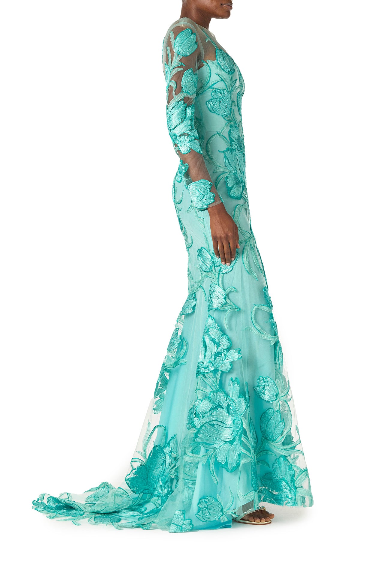 Monique Lhuillier Spring 2025 Embroidered, aqua floral tulle long sleeve trumpet gown with jewel neckline - side with train.
