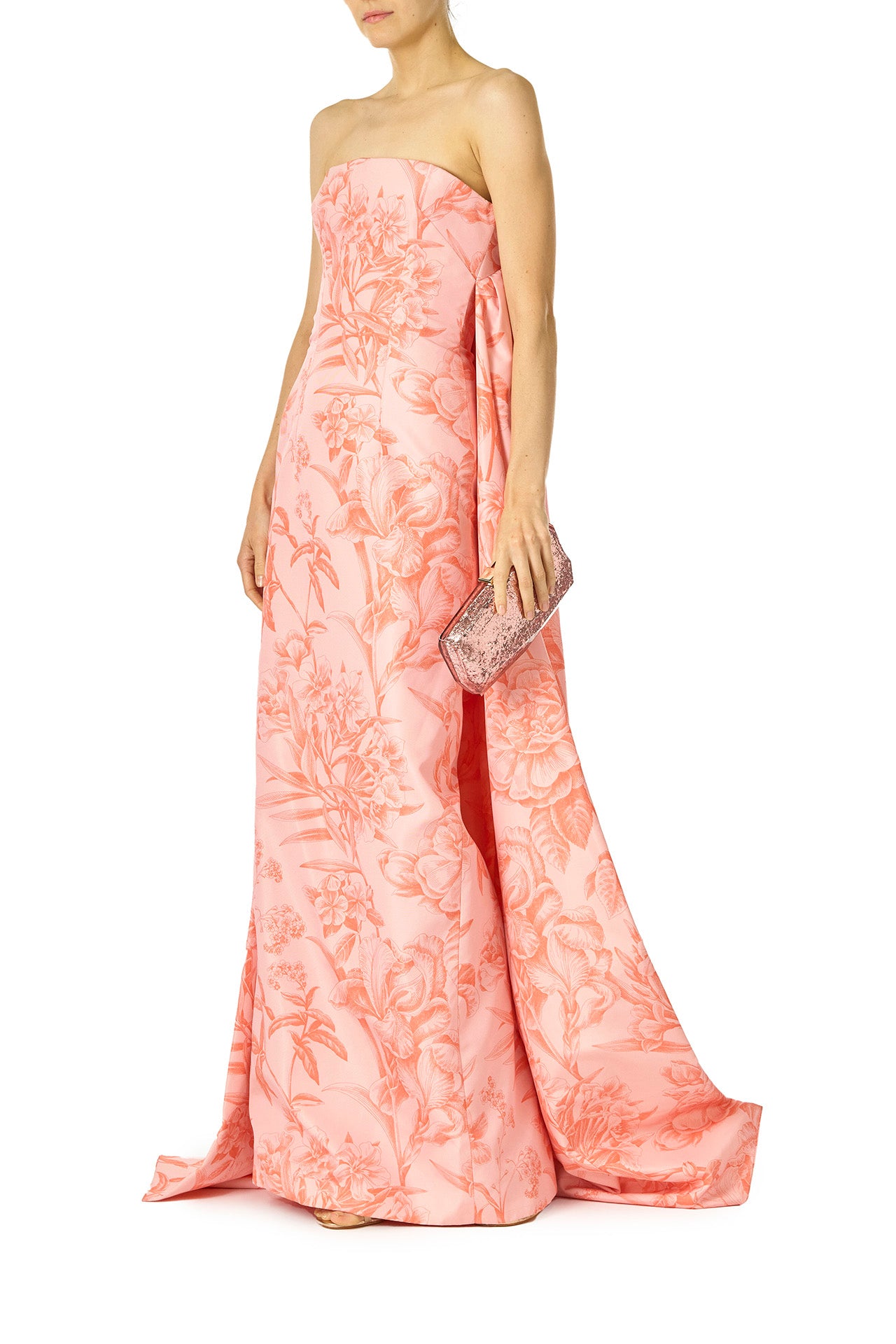 Monique Lhuillier Spring 2025 Strapless, column gown with sweeping integral train in rosette/coral colored Floral Toile Printed Faille - front with Viv bag.