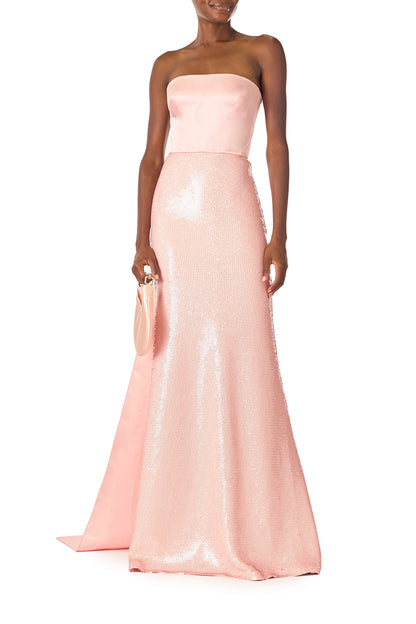 Monique Lhuillier Spring 2025 Strapless sequin column gown with satin bodice and floor length train in Rosette color - front with Demi bag.