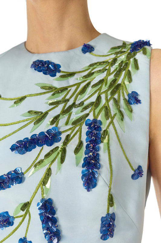 Monique Lhuillier Spring 2025 Sleeveless, tea-length dress with pockets in Powder Blue faille with Lavender-patterned embroidery - embroidery detail.