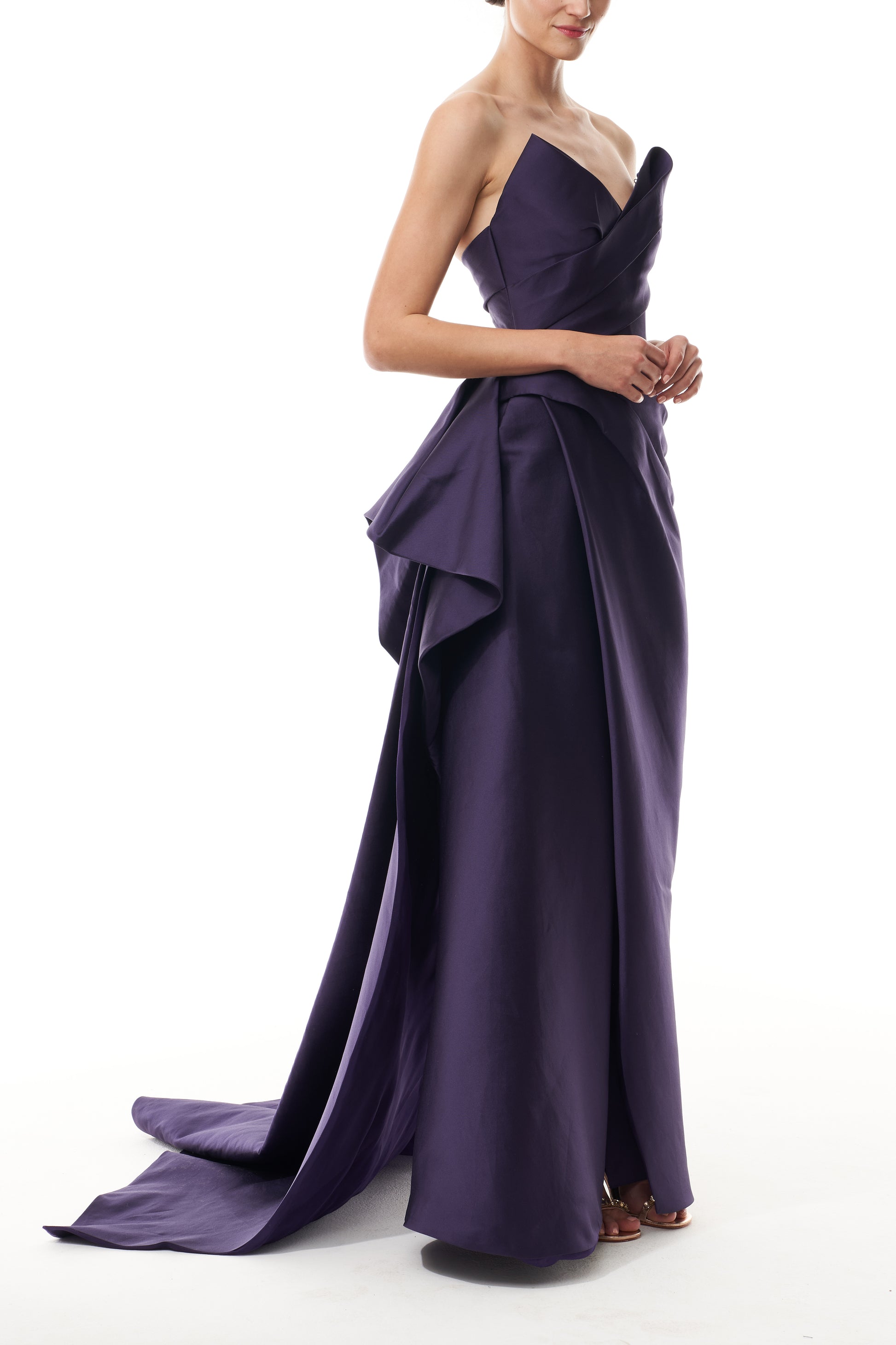 Monique Lhuillier Fall 2025 floor length gown with draped bodice and front leg slit in violet mikado fabric - side.