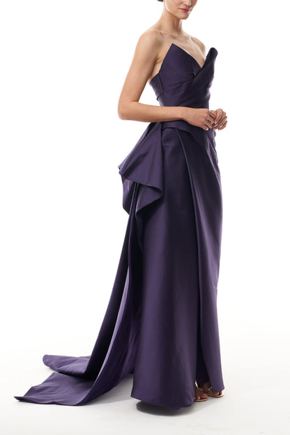 Monique Lhuillier Fall 2025 floor length gown with draped bodice and front leg slit in violet mikado fabric - side.