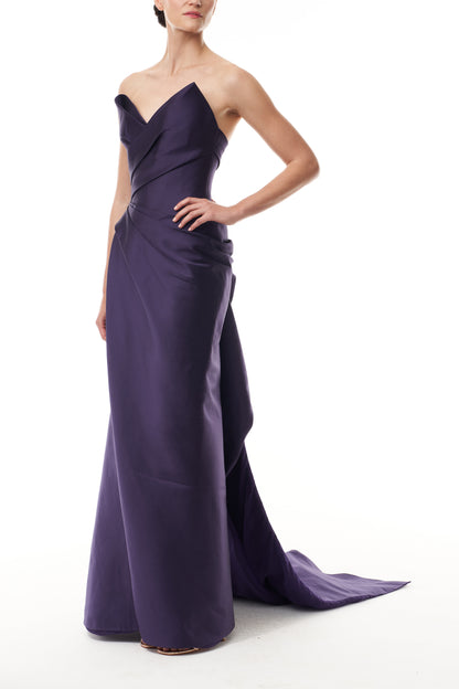 Monique Lhuillier Fall 2025 floor length gown with draped bodice and front leg slit in violet mikado fabric - side.