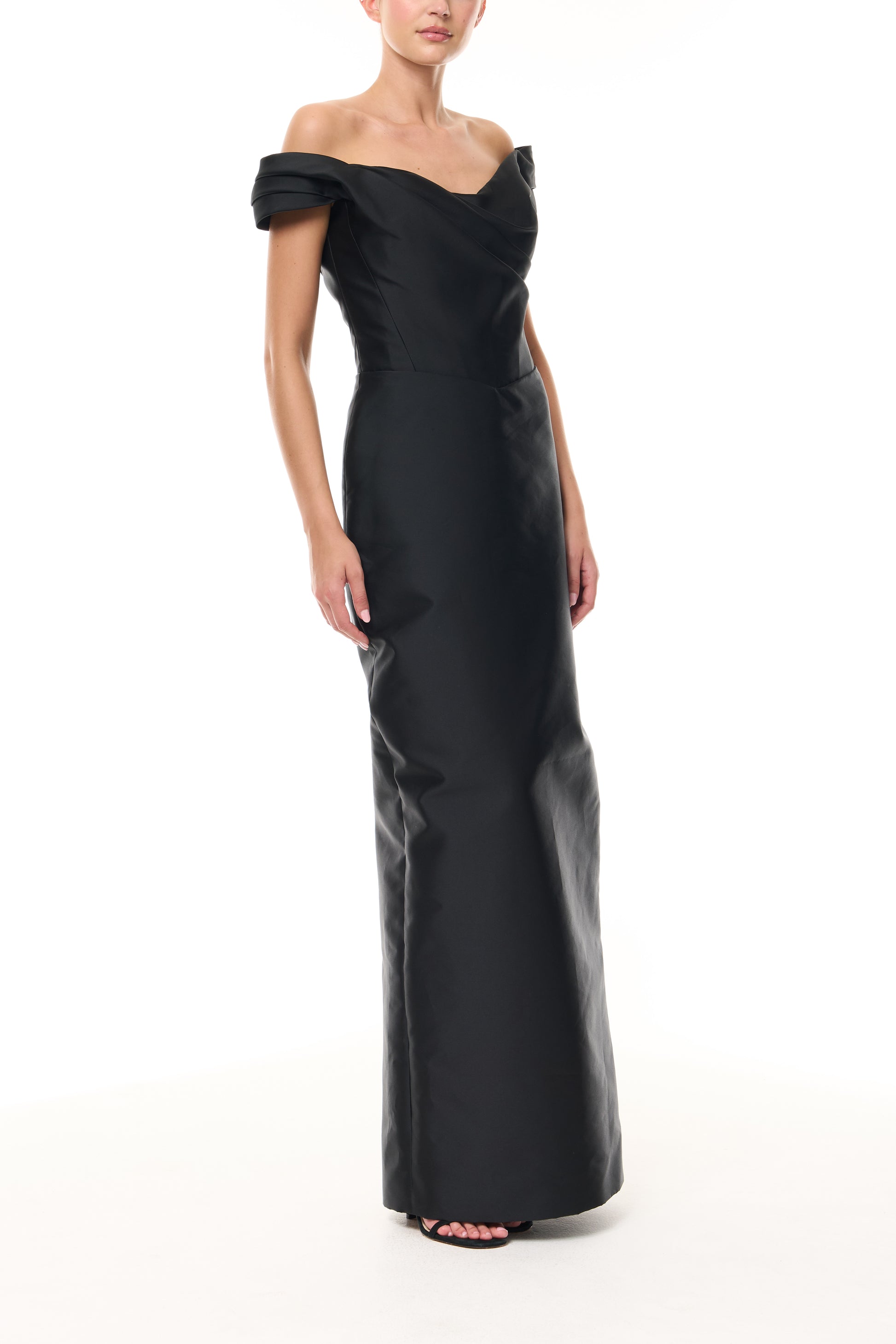 Monique Lhuillier Fall 2025 Noir Mikado Off-the-shoulder draped bodice column gown - side. 