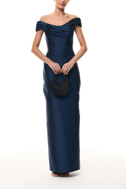Monique Lhuillier Fall 2025 Ocean Mikado Off-the-shoulder draped bodice column gown - front with Noir Demi Evening Bag.