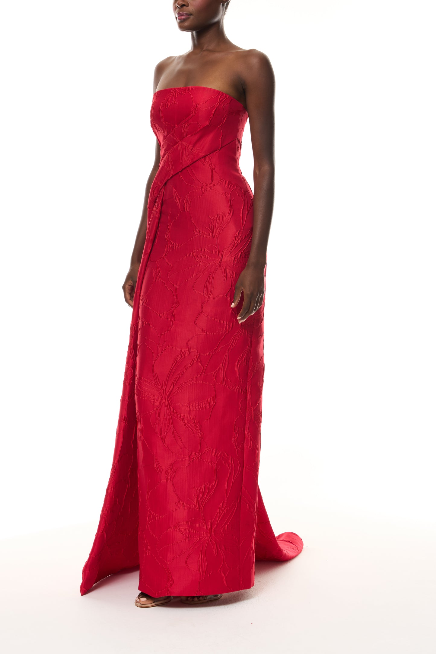 Monique Lhuillier Spring 2026 Poppy Linear Rose Jacquard Strapless Strapless draped column gown with train - side.