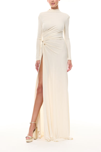 Monique Lhuillier Spring 2026 Ivory crepe jersey high neck long sleeved draped gown with slit and gold ball piercing - front.