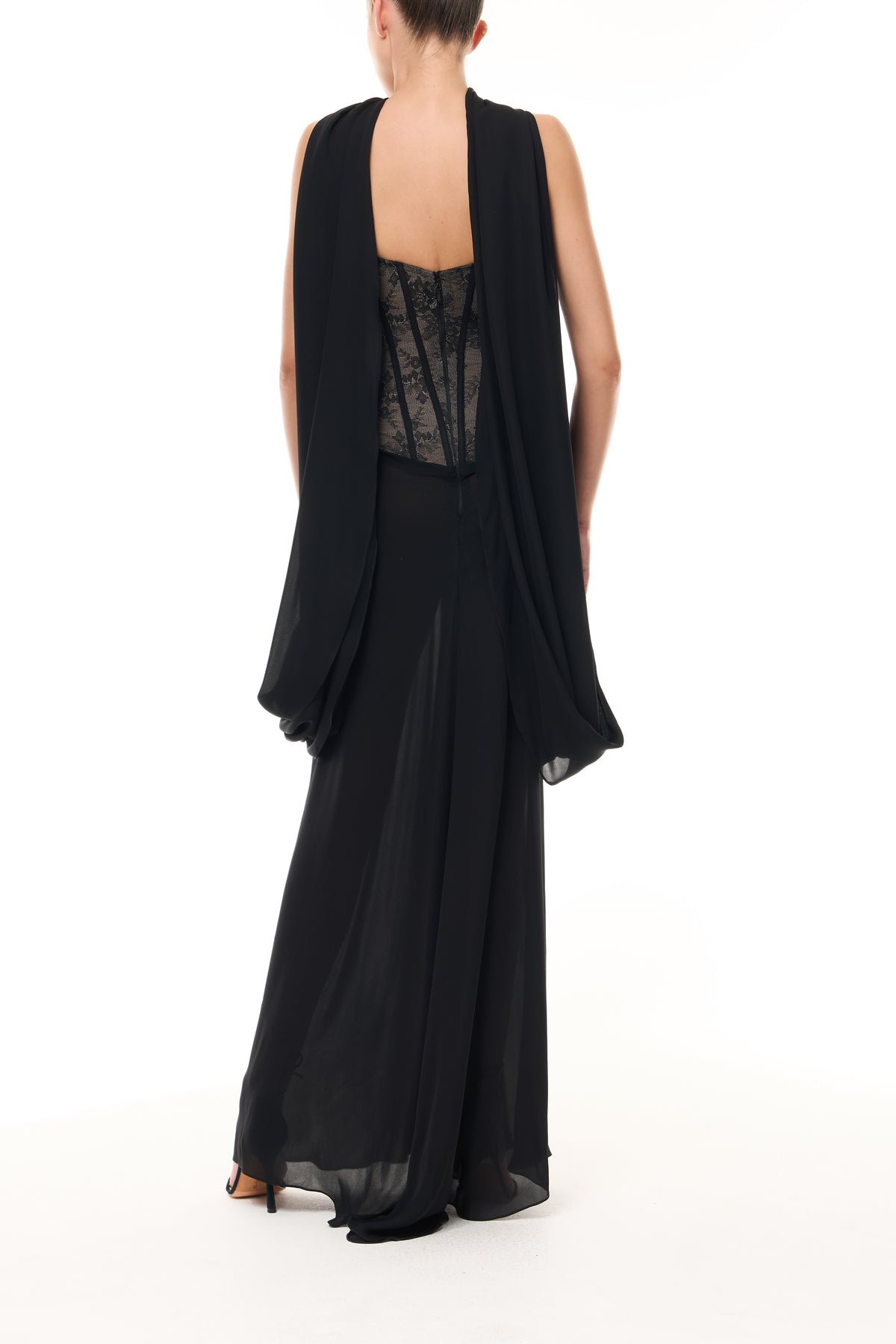 Monique Lhuillier Spring 2026 Noir lace and georgette corseted dropped waist gown with shawl - back.