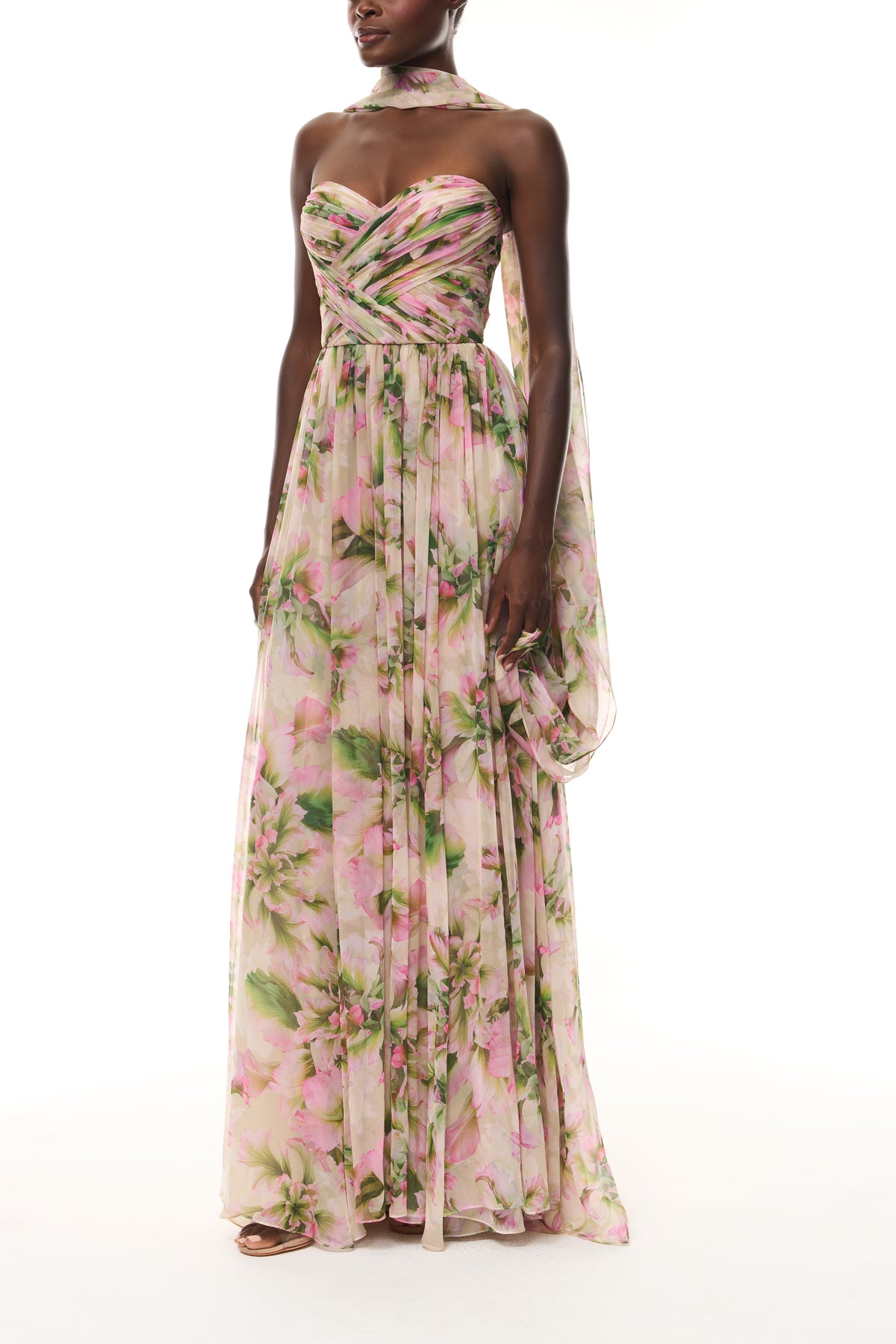 Monique Lhuillier Spring 2026 Carnation Multi Small Tulip Printed Chiffon Sweetheart strapless pleated gown with
shawl - side.