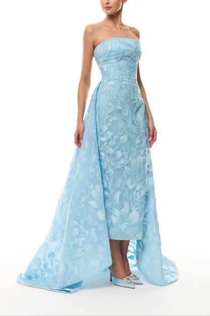 Monique Lhuillier Spring 2026 Plumeria Floral Corded Organza Strapless tea - length column gown with train - side.