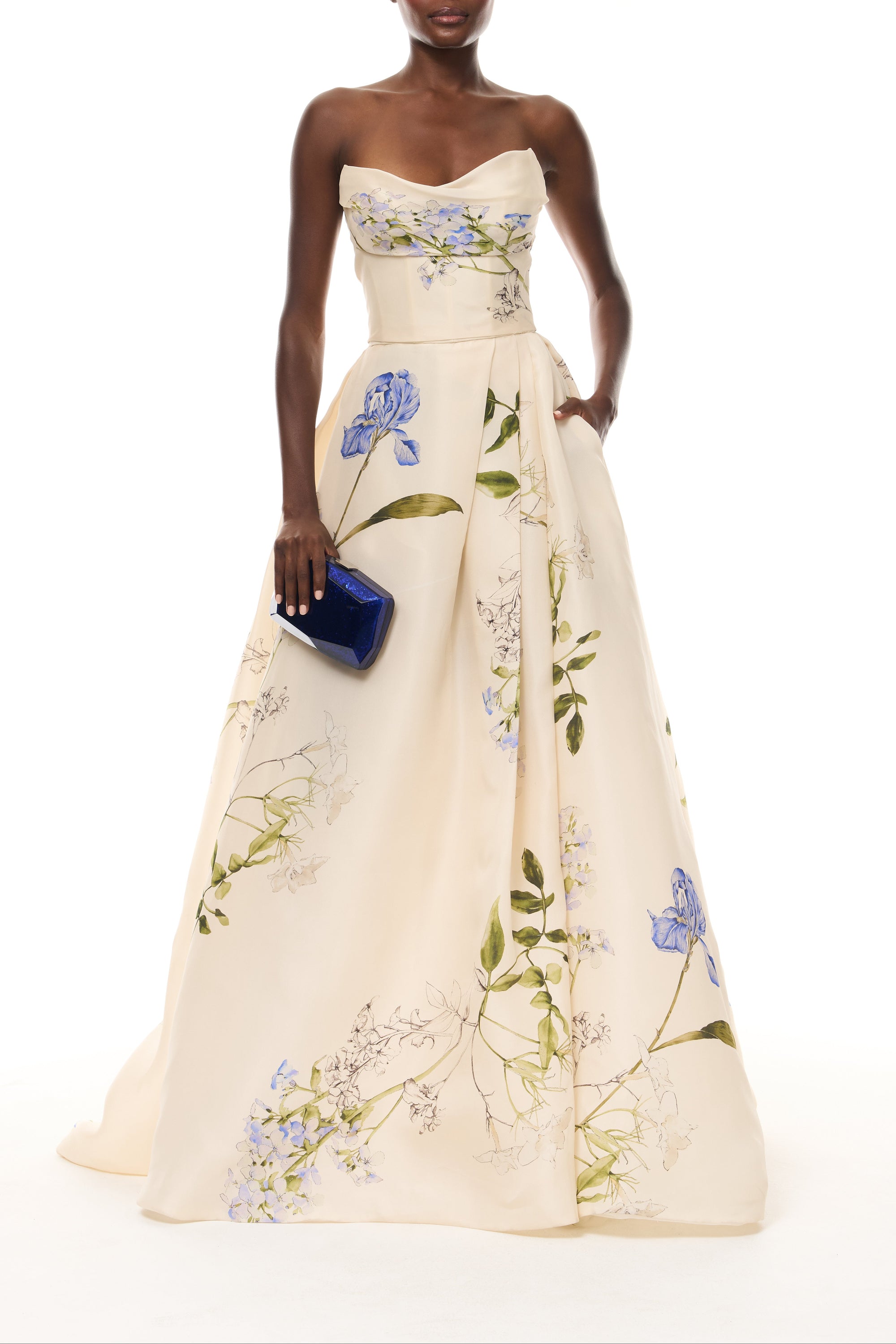Monique Lhuillier Spring 2026 Ivory Multi Iris Bouquet Printed Gazar Draped bodice
ball gown with front skirt slit - front with Blue Dasha Minaudière