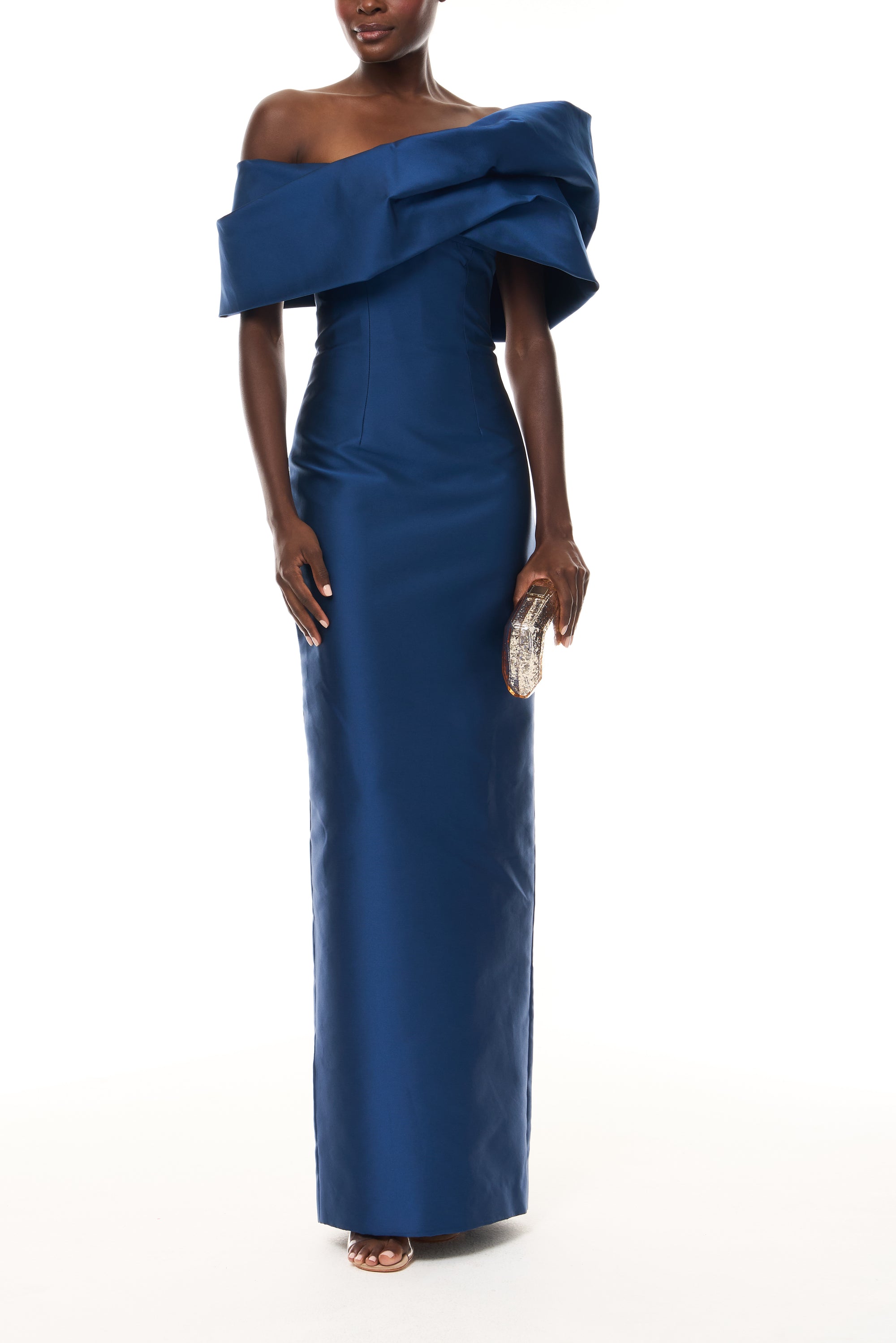 Monique Lhuillier Spring 2026 Navy Mikado Asymmetric drape neckline column gown - front with Gold Dasha Minaudière