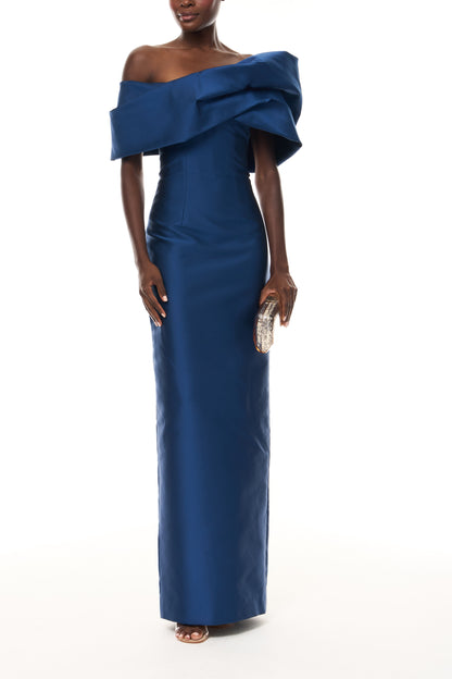 Monique Lhuillier Spring 2026 Navy Mikado Asymmetric drape neckline column gown - front with Gold Dasha Minaudière