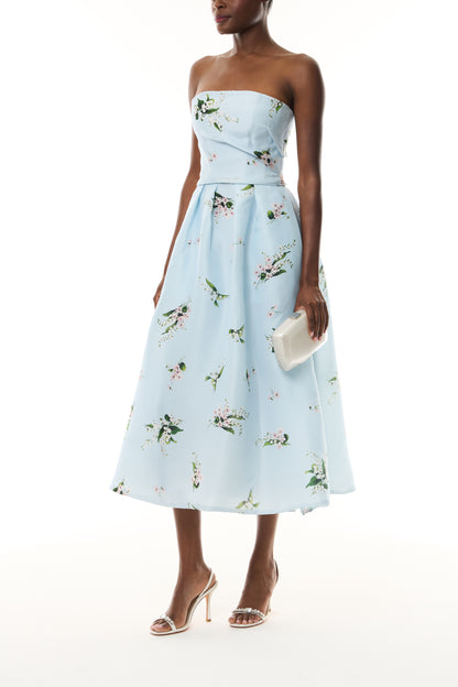 Monique Lhuillier Fall 2026 Breeze Multi Floating Posies Printed Gazar Strapless tea length dress - side with Crystal Dust Dasha Minaudiere.