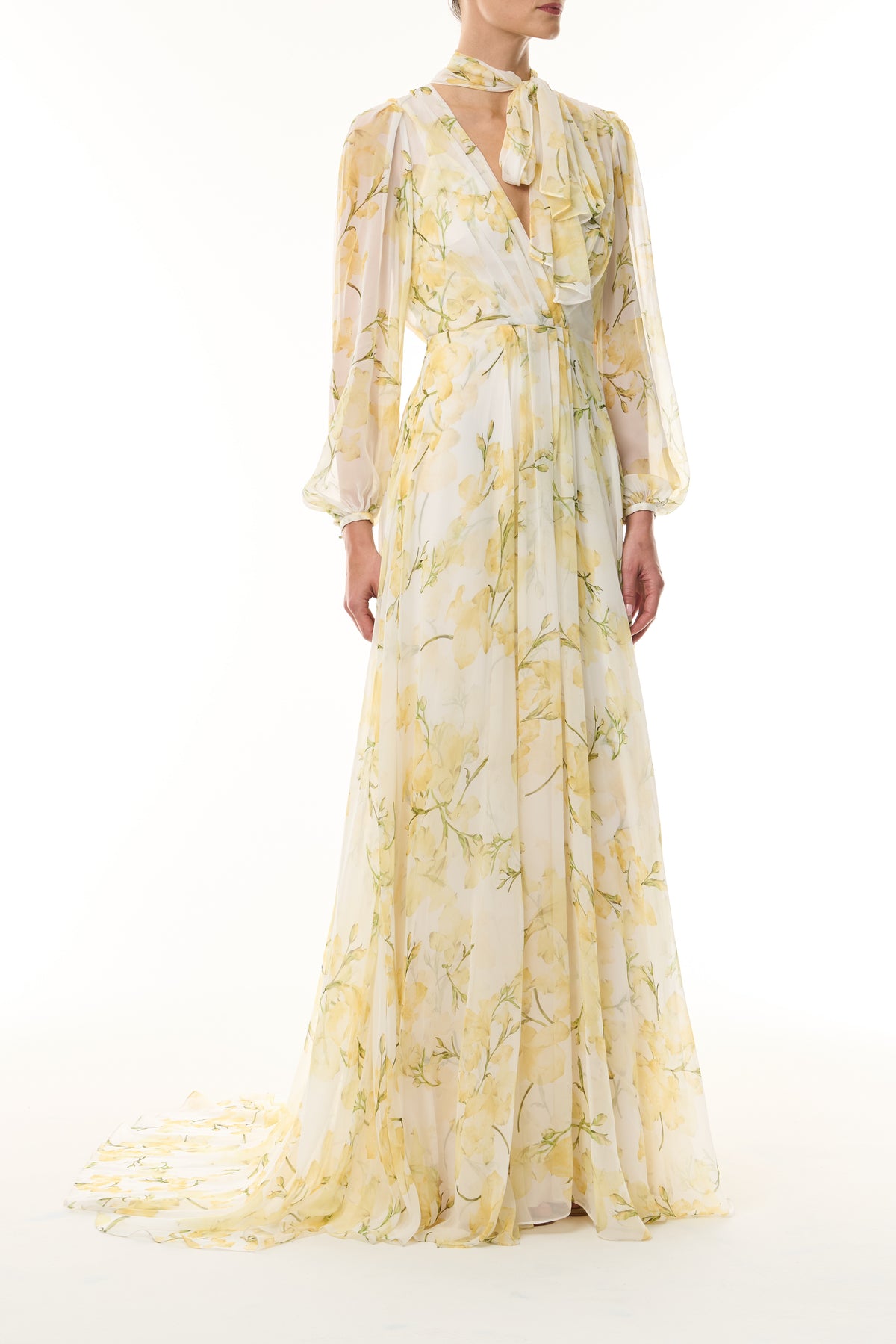 Monique Lhuillier Fall 2026 Pale Yellow/Multi Snapdragon Floral Printed Chiffon Draped V-neck long sleeve gown with blouson sleeves - front.