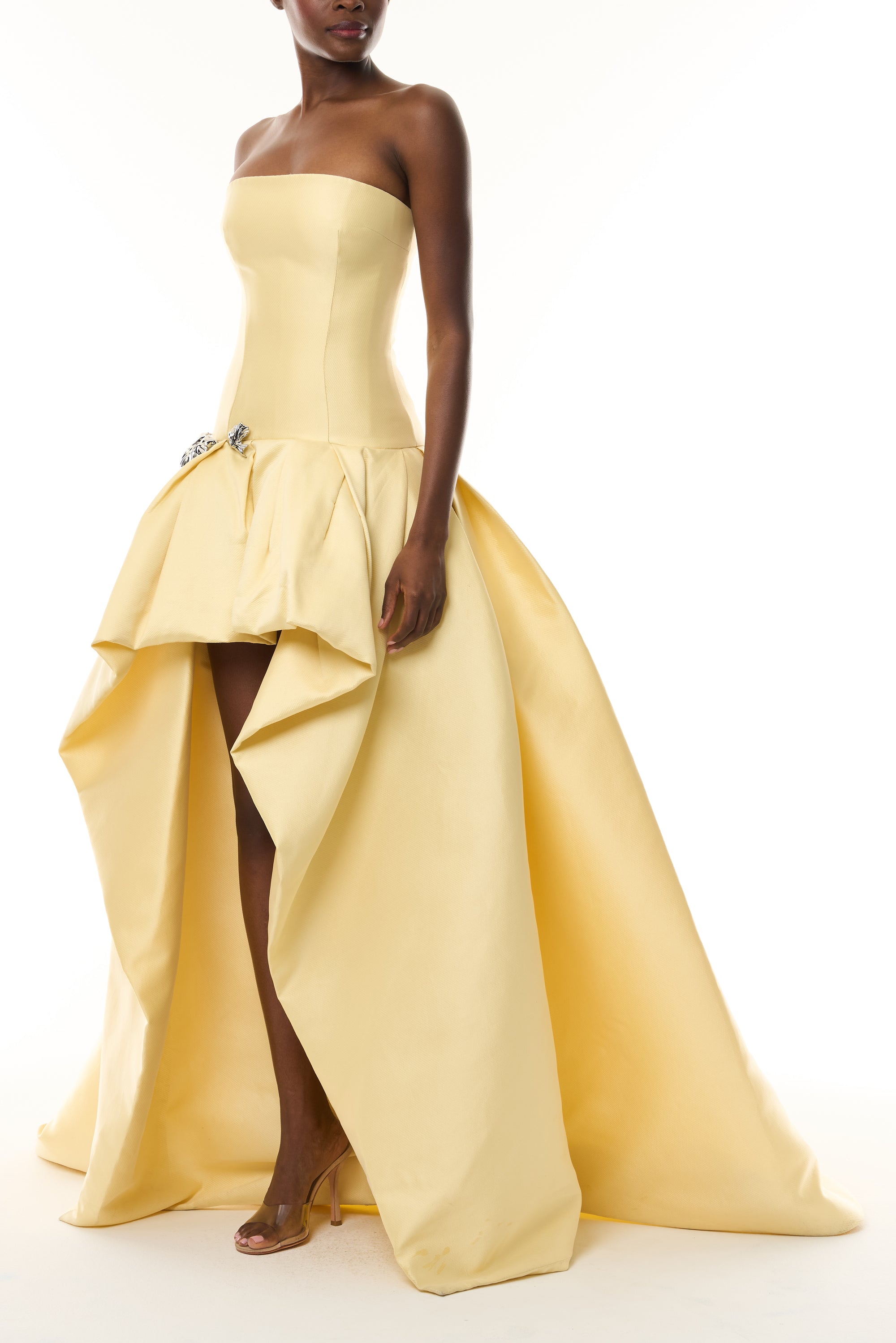 Monique Lhuillier Fall 2026 Pale Yellow Mikado Pique strapless ballgown with train and floral embellishment - side.