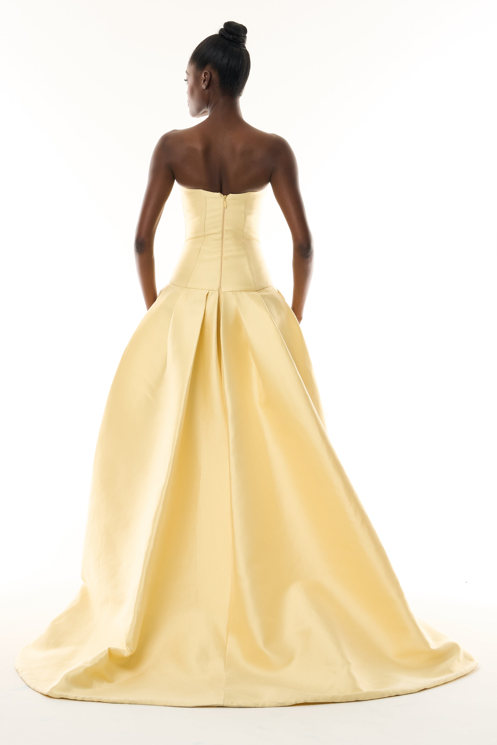Monique Lhuillier Fall 2026 Pale Yellow Mikado Pique strapless ballgown with train and floral embellishment - back.