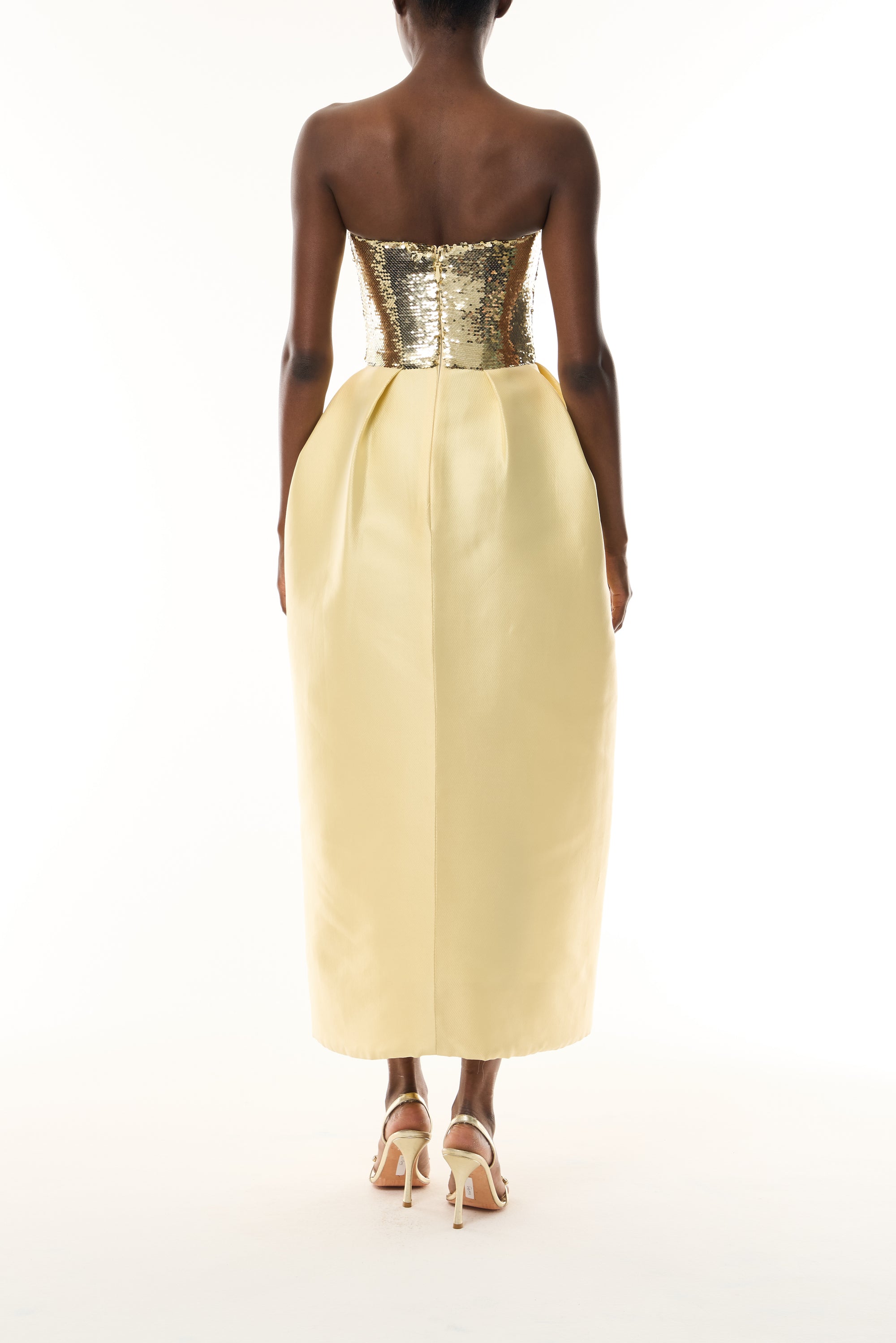 Monique Lhuillier Fall 2026 strapless midi dress with Gold sequin bodice and Pale yellow tulip cut Mikado Piqué skirt - back.