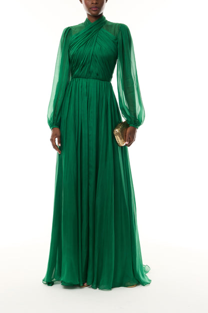Monique Lhuillier Fall 2026 Sycamore Iridescent Chiffon long sleeve draped bodice gown - front with Gold Dasha Minaudiere.
