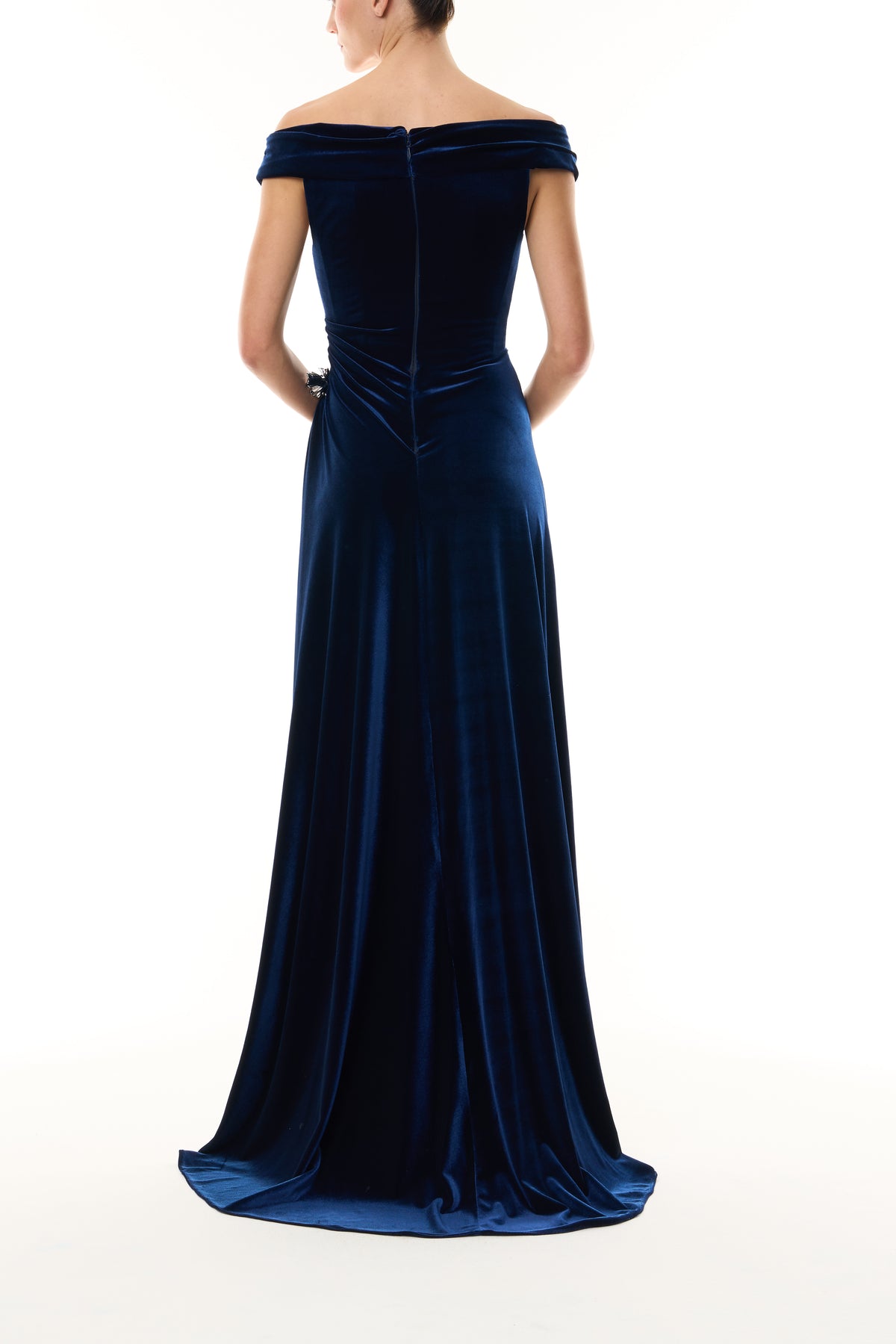 Monique Lhuillier Fall 2026 Navy off-the-shoulder stretch velour draped floor length gown with slit and silver floral embellishment - back.