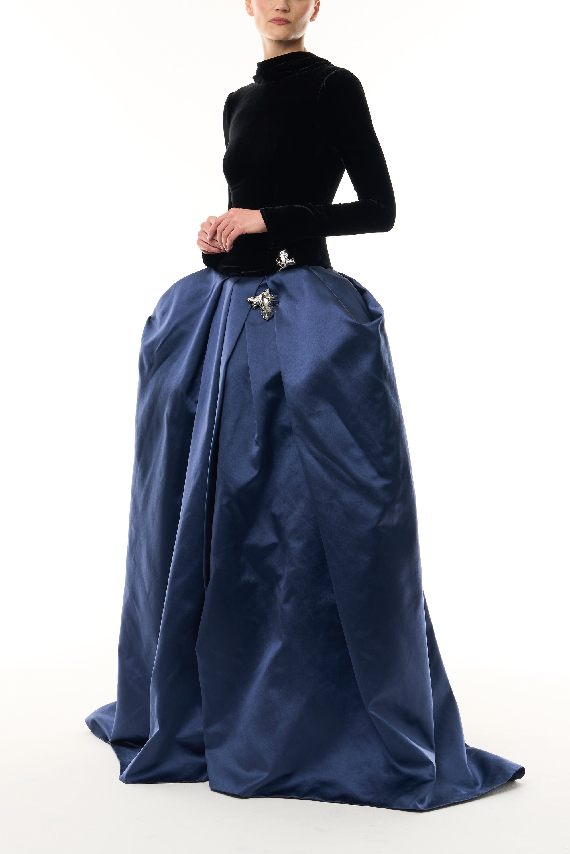 Monique Lhuillier Fall 2026 Noir and Navy Velvet and Duchess Satin long sleeve high neck pleated ballgown with silver floral embellishment - side.