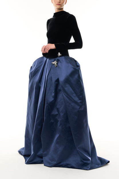 Monique Lhuillier Fall 2026 Noir and Navy Velvet and Duchess Satin long sleeve high neck pleated ballgown with silver floral embellishment - side. 