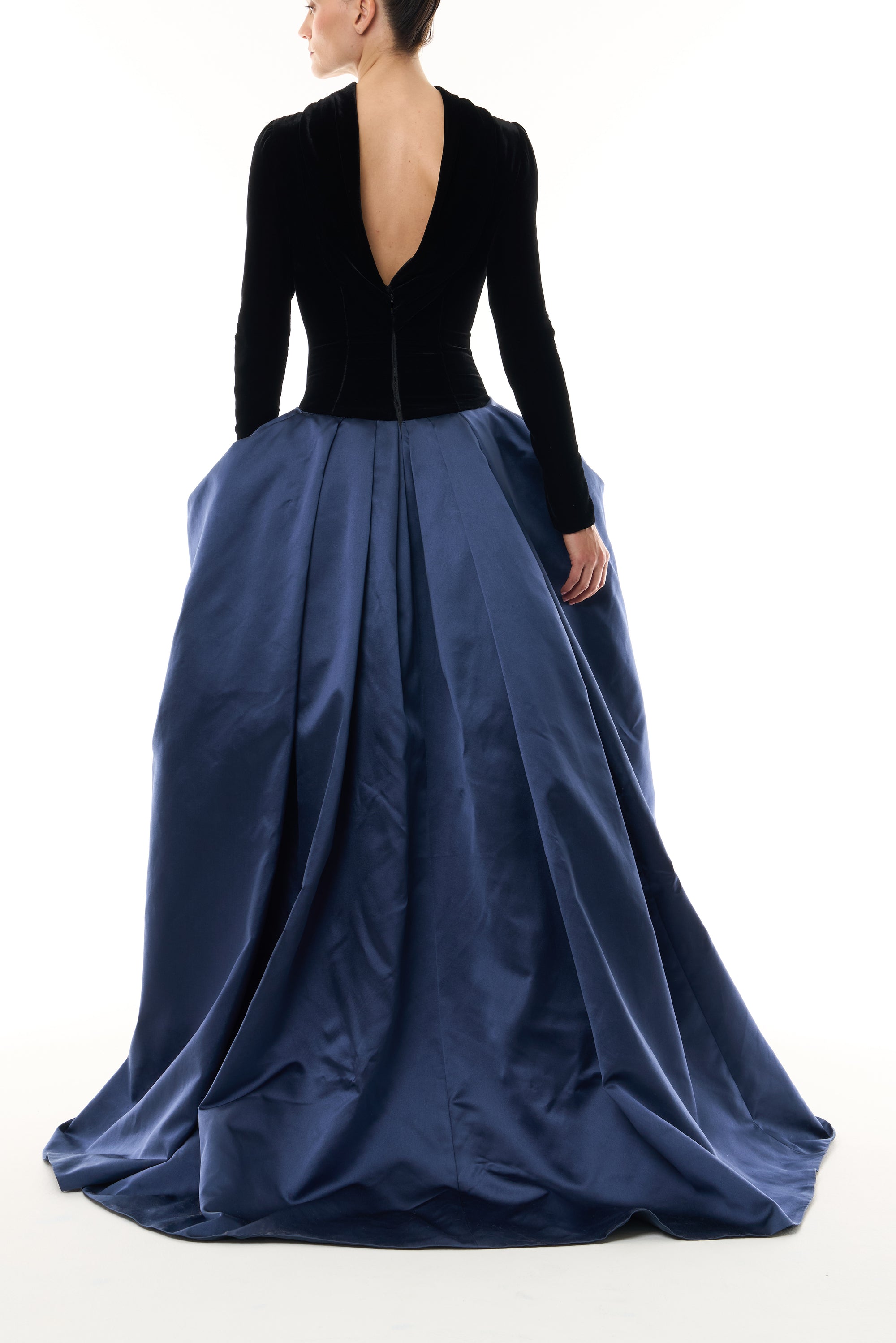 Monique Lhuillier Fall 2026 Noir and Navy Velvet and Duchess Satin long sleeve high neck pleated ballgown with silver floral embellishment - back.
