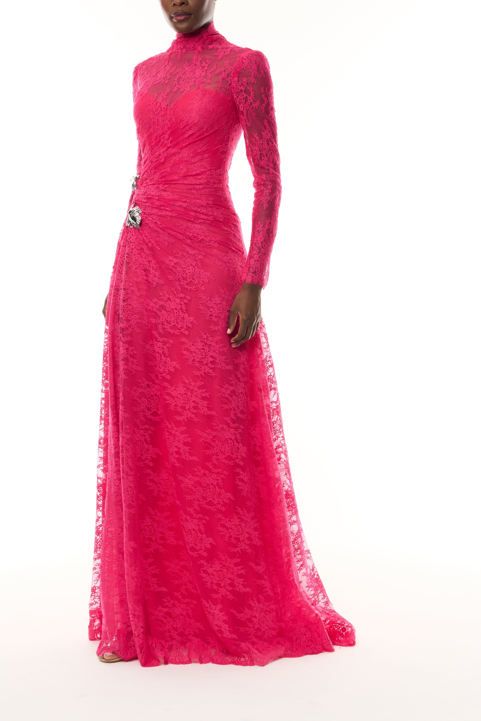 Monique Lhuillier Fall 2026 Pink Chantilly Lace high neck long sleeve gown with slit and silver floral embellishment - side.