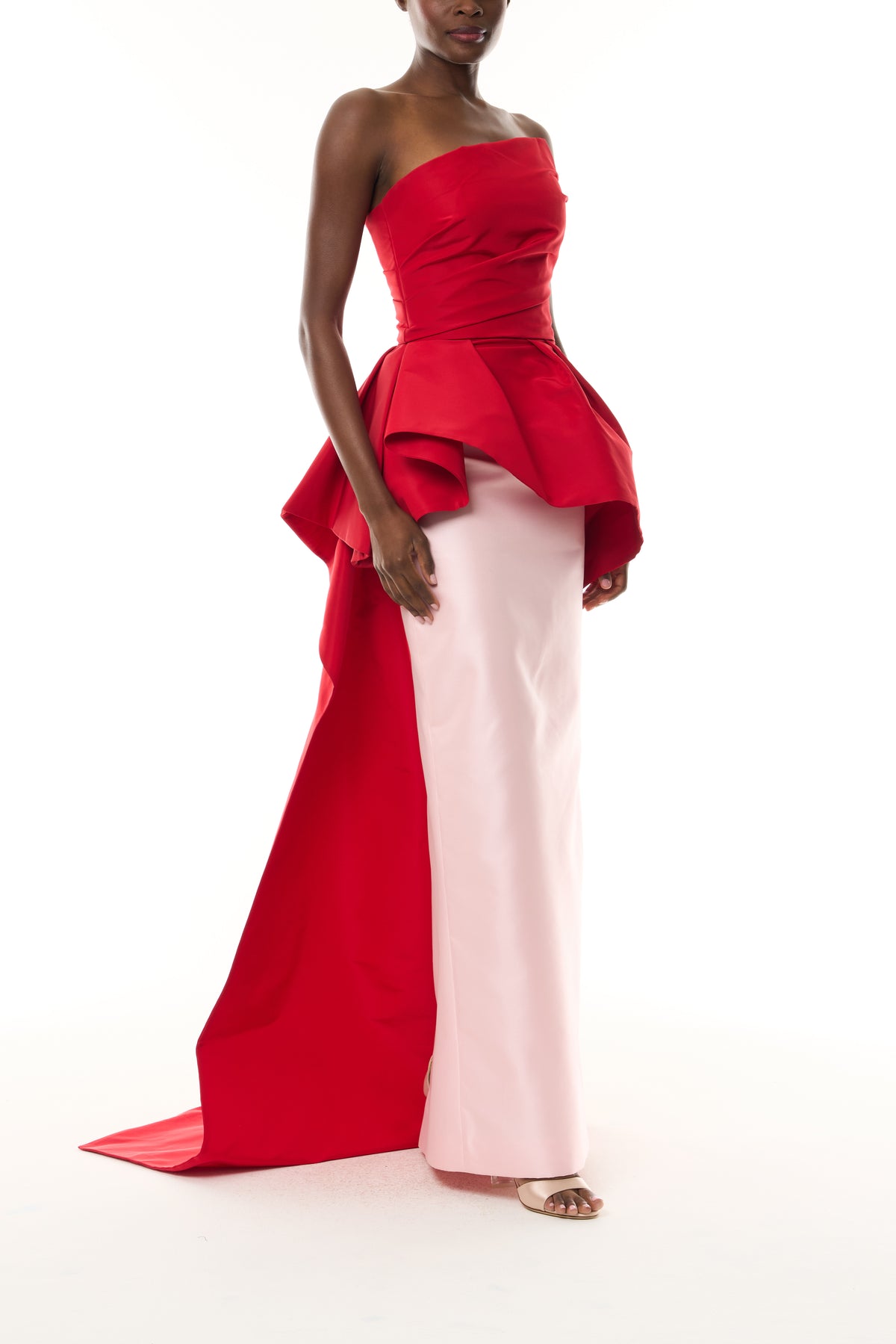 Monique Lhuillier Fall 2026 vibrant red and pale pink Silk Faille & Mikado strapless peplum bodice with column skirt and train - side.