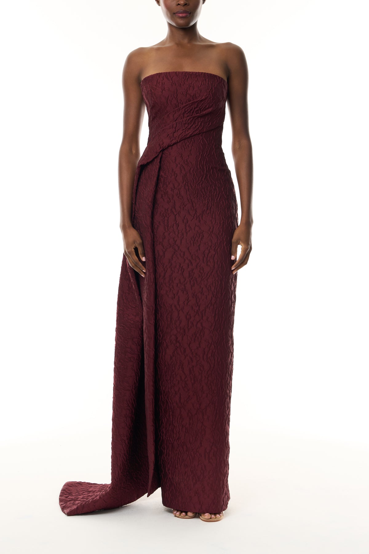 Monique Lhuillier Fall 2026 Rhubarb Jacquard strapless draped column gown with side train - front.