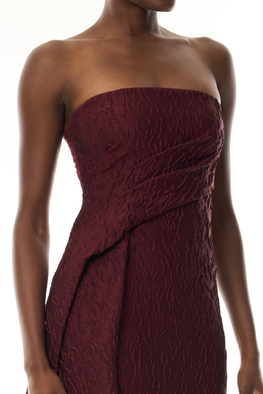 Monique Lhuillier Fall 2026 Rhubarb Jacquard strapless draped column gown with side train - fabric.