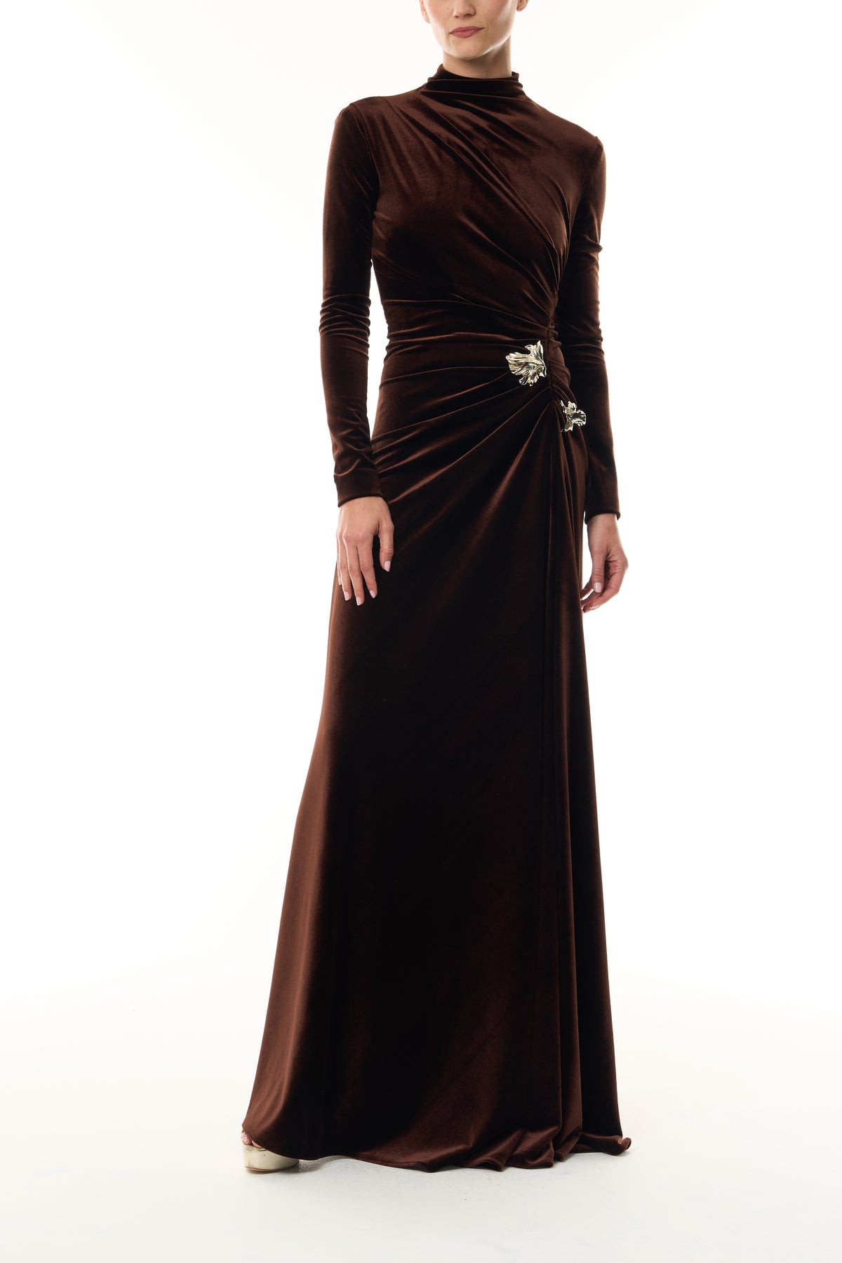 Monique Lhuillier Fall 2026 Café brown stretch velour high neck long sleeve gown with slit and gold floral embellishment - front.