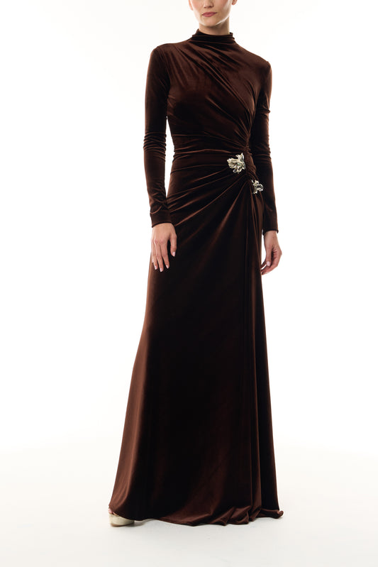 Monique Lhuillier Fall 2026 Café brown stretch velour high neck long sleeve gown with slit and gold floral embellishment - front. 