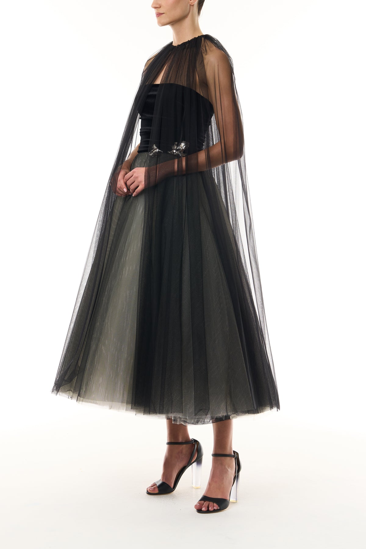 Monique Lhuillier Fall 2026 Noir / multi Stretch Velvet & Tulle strapless tea length dress with floral embellishment and coordinating noir tulle cape - side.