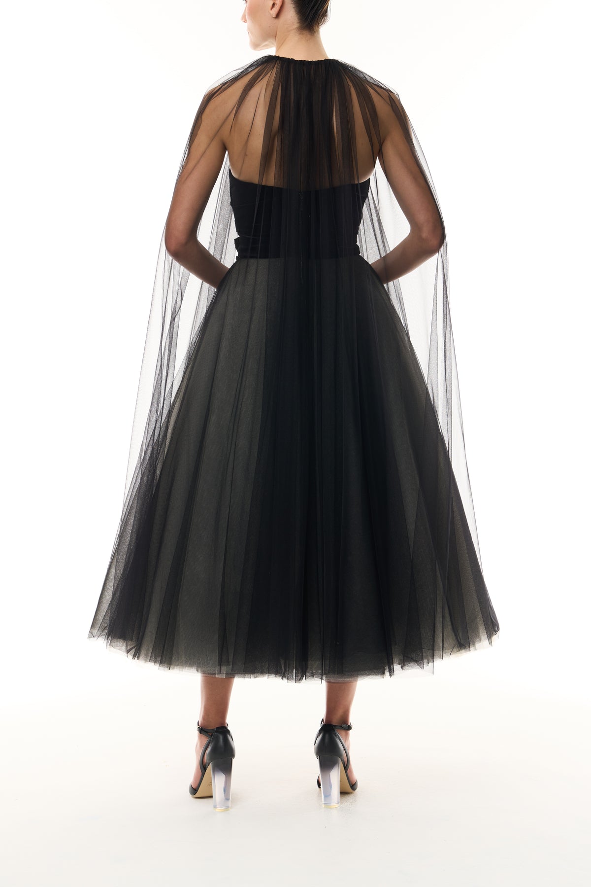 Monique Lhuillier Fall 2026 Noir / multi Stretch Velvet & Tulle strapless tea length dress with floral embellishment and coordinating noir tulle cape - back.