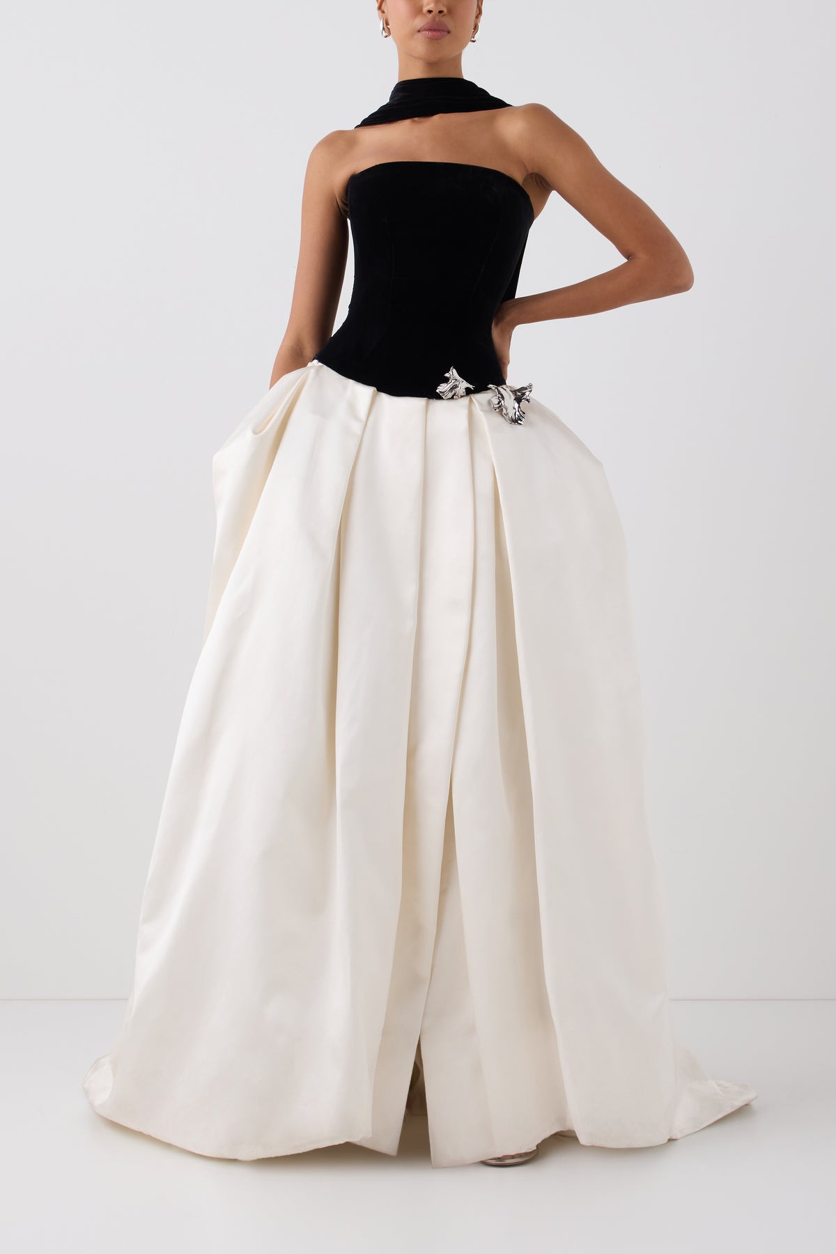 Monique Lhuillier Fall 2026 Noir and Silk White Satin and Velvet ball gown with silver floral embellishment and neck scarf -  front.