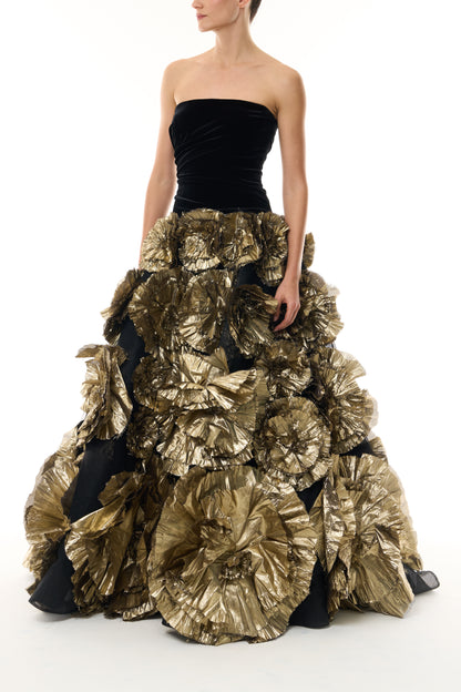 Monique Lhuillier Fall 2026 Noir/Gold velvet and embroidered lamé strapless dropped ballgown with three-dimensional floral skirt - front.