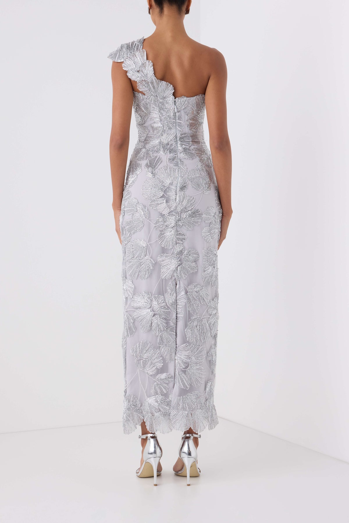 Monique Lhuillier Spring 2027 silver embroidered tulle one-shoulder tea length column gown - back.