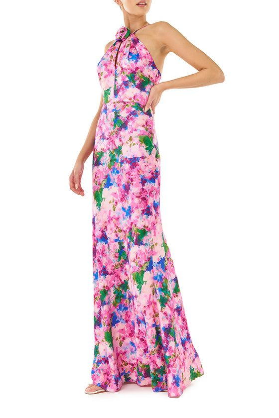ML Monique Lhuillier Spring 2024 floor length dress with rosette, halter neckline and low V-back in Waterlily Floral crepe-back satin - front two.