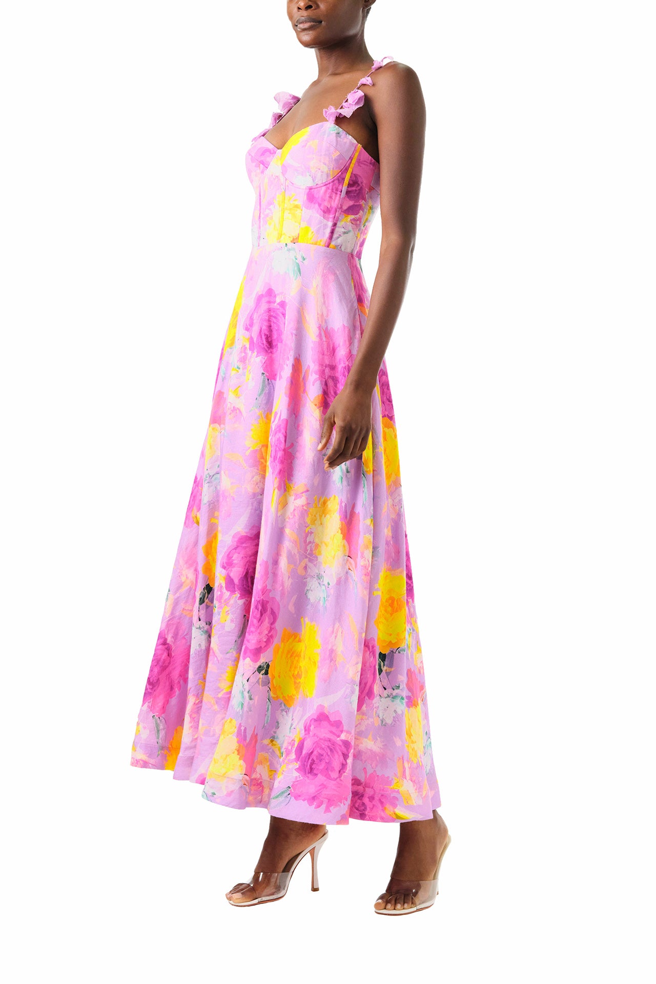 ML Monique Lhuillier 2024 Sleeveless midi dress with floral appliqued spaghetti straps and corset bodice in pink, purple and yellow floral printed linen - left side.