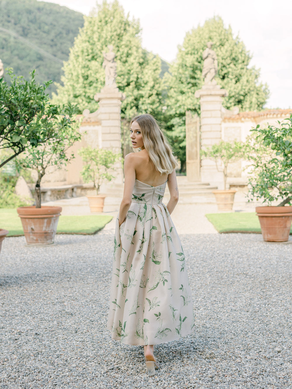 Monique Lhuillier strapless, midi length "Florette" dress in blush & leaf printed organza - lookbook photo on model.