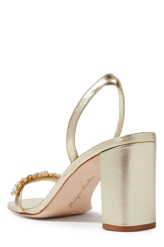 Monique Lhuillier Hollis heel in gold leather with rhinestone toe strap and block heel.