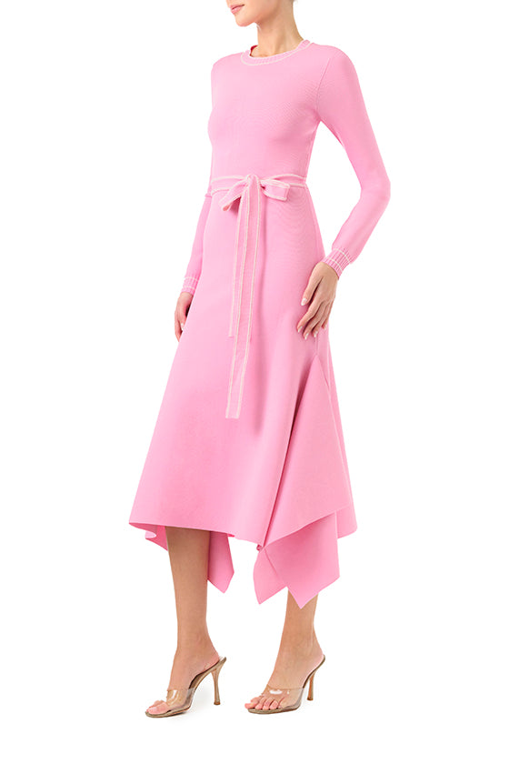 Monique Lhuillier Fall 2024 pink knit long sleeve dress with handkerchief hem and self-tie belt - left side.