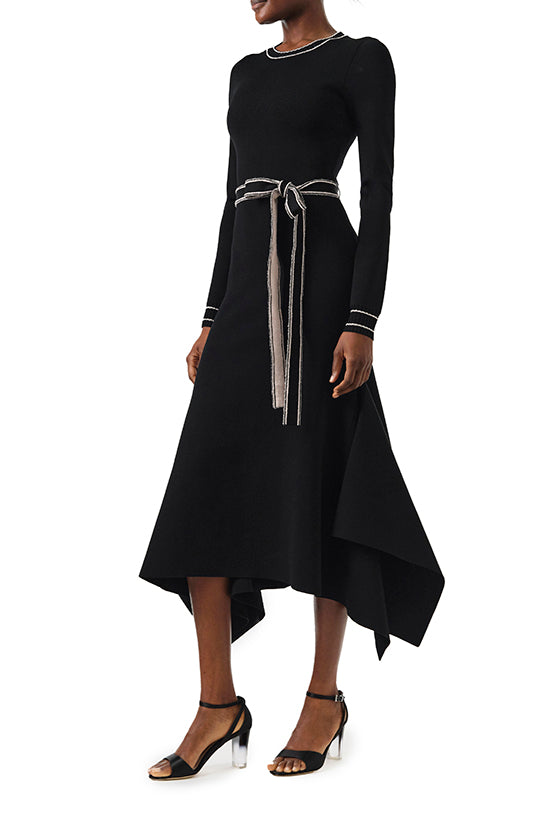 Monique Lhuillier Fall 2024 black knit long sleeve dress with handkerchief hem and self-tie belt - side.