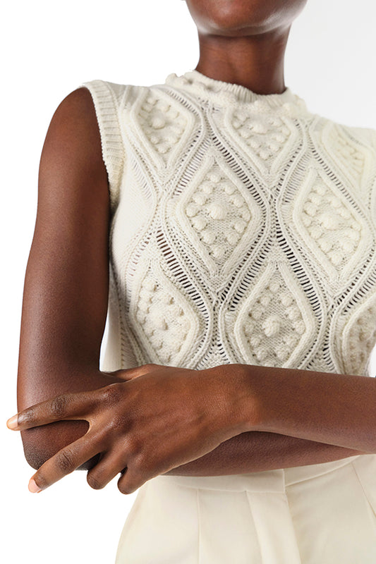 Monique Lhuillier Fall 2024 sleeveless, bobble crop tank in Creme wool cable knit - front crop.