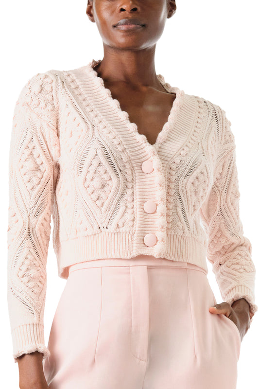 Monique Lhuillier Fall 2024 long sleeve, cropped bobble cardigan in Pale Blush wool cable knit - front crop.