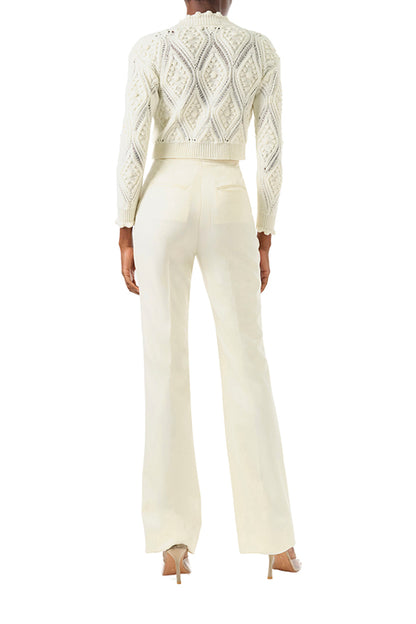 Monique Lhuillier Fall 2024 long sleeve, cropped bobble cardigan in Creme wool cable knit - back.