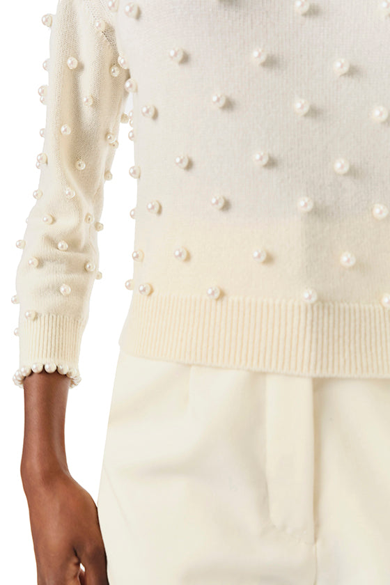 Monique Lhuillier Fall 2024 creme cashmere long sleeve sweater with pearl embroidery and trim - ribbed waistline.